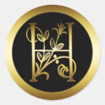 LETTRE FLORALE H DE MONOGRAMME D'OR AUTOCOLLANT ROND