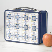 A blue and white metal lunchbox with a geometric  (En situation)