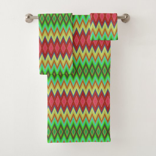A colorful, geometric-patterned towel set hangs bad handdoek (Insitu)