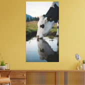A cow drinks water in a natural stream canvas afdruk (Insitu (Woonkamer))