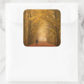A woman walking with her dog in fall sticker (Sac)