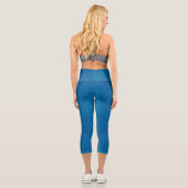 A woman's torso and legs in blue capri leggings (Verso)
