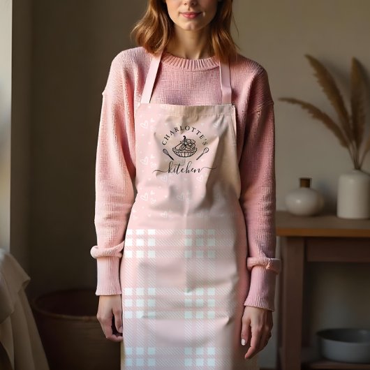 Aangepast roze keukengerei en broodbakken schort
