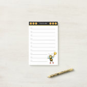 Abeille miel mignonne sur les notes post-it noir e (Sur un bureau)
