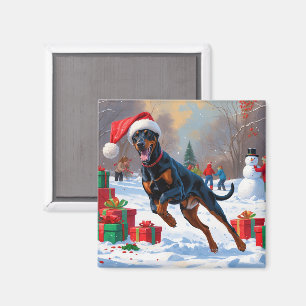 Aimant Doberman courant dans la neige avec un chapeau de