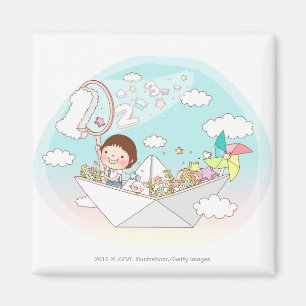 Aimant Garçon assis dans un bateau en papier