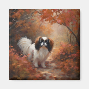 Aimant Japanese Chin dans les feuilles d'automne tombent