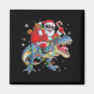 Aimant Père Noël de Noël à cheval sur un dinosaure Lumièr