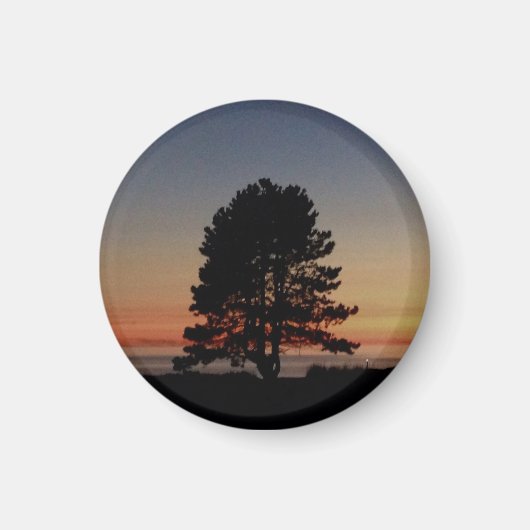 Aimant rond avec coucher de soleil de silhouette d (Devant)