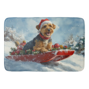 Airedale-hond in slee laat het sneeuwen Kerstmis Badmat