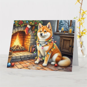 Akita zittend bij open haard met kerstlichtjes kaart