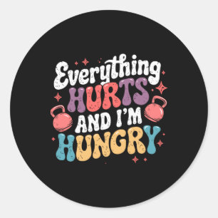 Alles doet pijn en ik heb honger gewichtheffer gra ronde sticker