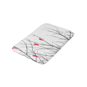 Artistieke heldere rode vogels op boomtakken badmat