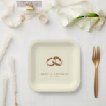 Assiettes En Carton Elegant Gold Minimalist Rings<br><div class="desc">This elegant wedding plate features a minimalist design with two interlocking golden rings set against a soft beige background, creating a luxurious and sophisticated look. The clean layout emphasizes the unity symbolized by the intertwined rings, while the classic serif font adds a touch of formality to the overall aesthetic. Perfect...</div>