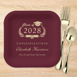 Assiettes En Carton Élégant Script Bourgogne Red Gold Graduation<br><div class="desc">Élégante plaque de papier de la fête de graduation rouge bordeaux avec "Classe de" dans une illustration en or clair de couronne de laurier incorporant un casquette et un diplôme,  le nom du diplômé dans un script d'or élégant,  et "Félicitations" et leur nom d'école dans la typographie or moderne.</div>