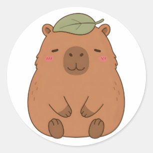 Autocollant de capybara mignon avec une feuille ve