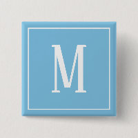 Bouton carré blanc sur fond bleu clair avec monogr