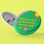 Badge Rond 5 Cm L'avortement est une féministe des droits humains<br><div class="desc">L'avortement est un droit humain fondamental écrit en police jaune rétro sur un bouton funky style hippie pour une féministe pro choix. Montrez votre esprit amusant avec ce mignon bouton vert avec de jolies fleurs tout en défendant les droits des femmes et le mouvement pro-choix.</div>