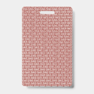 Badge Tissus rouges et roses posés sur un tapis à motifs