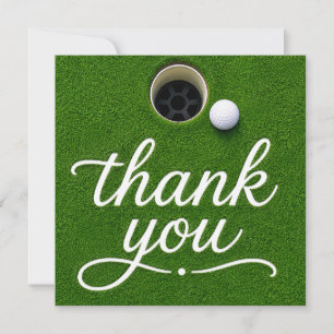 Balle de golf à côté du trou merci sur gazon vert