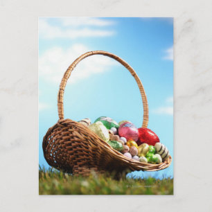 Basket filled with Easter eggs on grass Feestdagenkaart