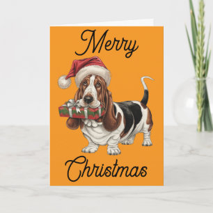 Basset Hound in kerstmuts met cadeau in de bek Kaart