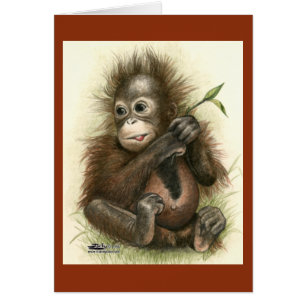 Bébé orang-outan avec des feuilles