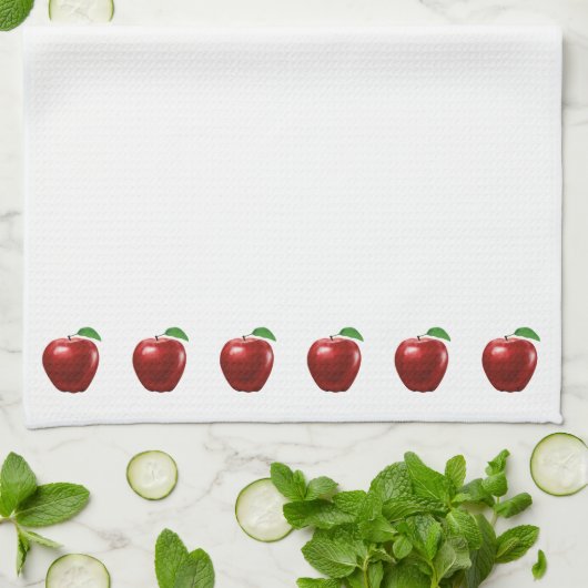 Belles pommes rouges sur une serviette de cuisine (Plié)