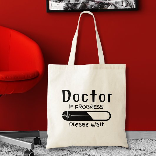 Bezig met de arts Een ogenblik geduld Tote Bag