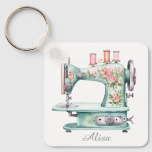 Blauwe bloemensleutelhanger met naaimachine sleutelhanger