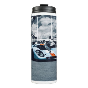 Blauwe en oranje raceauto thermosbeker