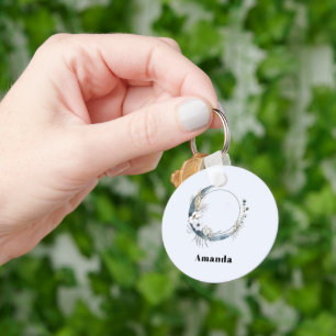 Blauwe halve maan met witte bloemen sleutelhanger