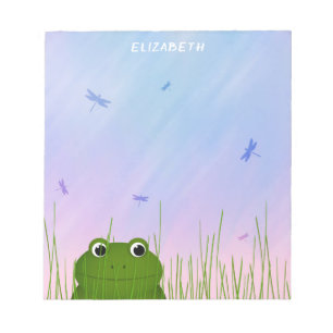 Bloc-note grenouille de dessin animé regardant à travers l'h