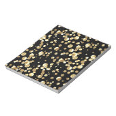 Bloc-note Pois or sur un arrière - plan noir. (Tourné)