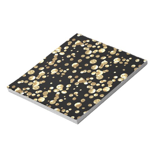 Bloc-note Pois or sur un arrière - plan noir. (Tourné)