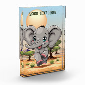 Bloc Photo Un bébé éléphant qui sonne heureux dans la savane (Gauche)