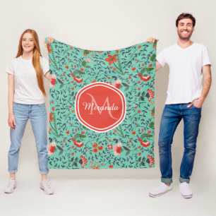 Bloemmotief in turkoois en oranje en rode monogram fleece deken