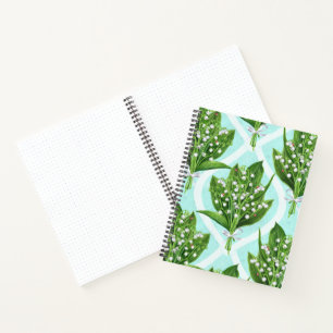 Boeket van lelie van de vallei bloemen op blauw notitieboek
