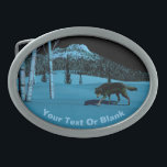 Boucle De Ceinture Ovale Loup d'hiver - Tapetum Lucidum<br><div class="desc">Un loup marchant la nuit sur la neige rouillée; un pic couvert d'arbres dans l'arrière - plan. Le clair de lune reflète la neige et l'écorce pâle des bouleaux. Les yeux du loup brillent aussi de lumière lune réfléchie. Ajoutez votre propre texte. La qualité réfléchissante de nombreux yeux d'animaux est...</div>