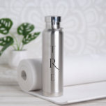 Bouteille D'eau Chic Monogramme sur Argent<br><div class="desc">Le chic monogramme vertical noir sur argent présente une plus grande originalité décorative au centre. Remplacez les 3 initiales par les vôtres dans la barre latérale. Autres couleurs et styles de bouteilles d'eau disponibles dans la barre latérale. Copyright © Claire E. Skinner. Tous droits réservés.</div>