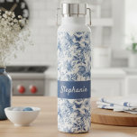 Bouteille D'eau Vintage Blue Floral Toile Monogram<br><div class="desc">Elevate your style with this gorgeous blue toile floral insulated water bottle, personalized just for you! Featuring a timeless blue and white toile-style botanical pattern that evokes classic elegance, this design is as beautiful as it is functional. The rich blue panel is customized with a graceful script, making it a...</div>