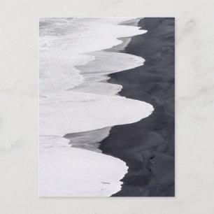 Breedte wasgoed over zwart strand briefkaart