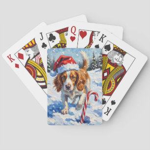 Brittany Spaniel-hond die naar Kerstsnoep wijst Pokerkaarten