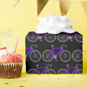 Cadeau bicyclette violette sur papier d'emballage noir