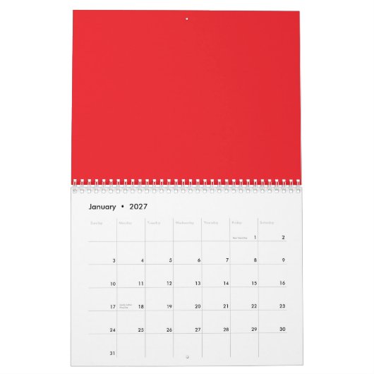Calendrier crayons rouges et oranges couchés côte à côte sur (Jan 2027)