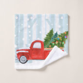 Camion pick-up rouge de Noël sur une route de (Gant de toilette)