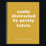 Carnet Drôle Quote de structure de chicane Nom personnali<br><div class="desc">Un incontournable pour les amateurs de tissus et de couture ! Ce carnet amusant et élégant comprend l'expression "Facilement distrait par un joli tissu" en typographie audacieuse sur un arrière - plan de moutarde chaud. Idéal pour mettre en commun les idées de projet, les nuances de tissu et les inspirations...</div>