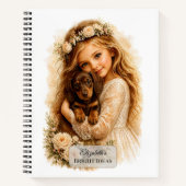 Carnet Fille serrant un chiot teckel dans ses bras (Devant)