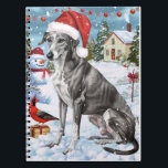 Carnet Greyhound Winter Wonderland Christmas Joie<br><div class="desc">Ce design festif reflète l'esprit joyeux de la période des fêtes, avec un adorable petit portant un chapeau de Père Noël. Le chien est niché dans un pays des merveilles hivernales, avec un bonhomme de neige, un sapin de Noël décoré et des cadeaux joliment emballés. Les flocons de neige tombent...</div>