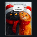 Carnet Meowy Christmas Winter Love<br><div class="desc">Une scène fantaisiste et festive pleine de joie et d'amour pour un chat noir heureux et un chat orange,  tous deux portant des chapeaux de Père Noël,  entourés de chutes de flocons de neige.</div>